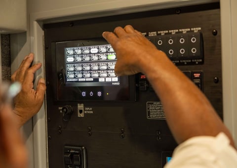 A man utilizing the Frontline Communications Command Zone™ Electrical Systems Screen.