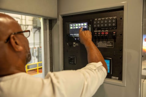 A man utilizing the Frontline Communications Command Zone™ Electrical Systems Screen.