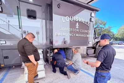 Individuals inspection Louisville Metro Emergency Services' Mobile Command Vehicle.