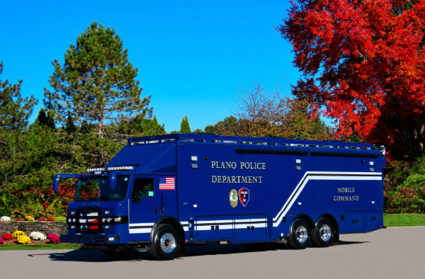 A Frontline Communications Mobile Command Vehicle for Plano Police Department parked outside on a sunny day.