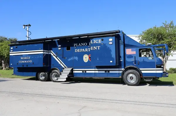 A Frontline Communications Mobile Command Vehicle for Plano Police Department parked outside on a sunny day.