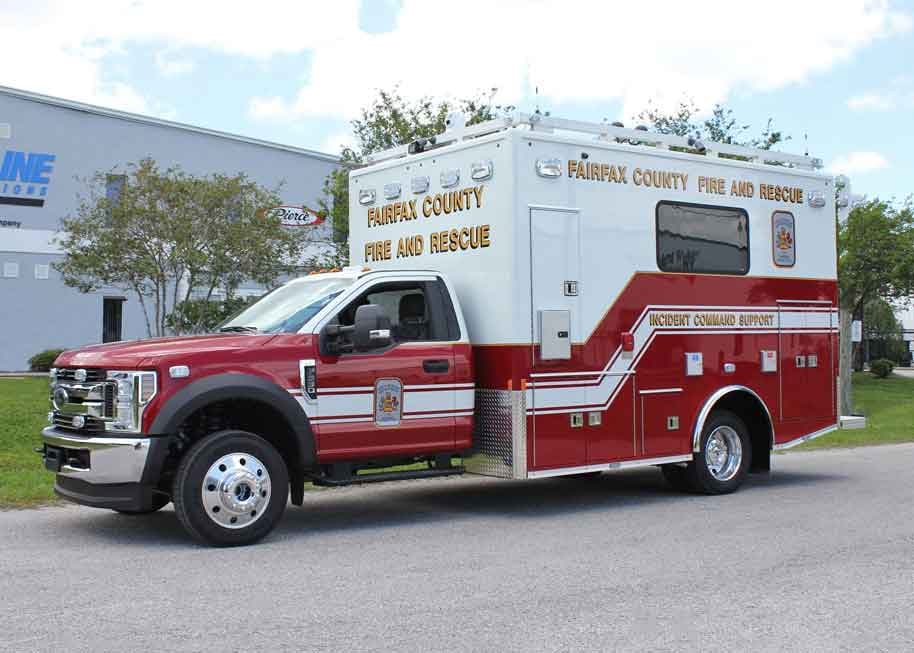 Frontline Communications small mobile command vehicle parked outside on a cloudy day.