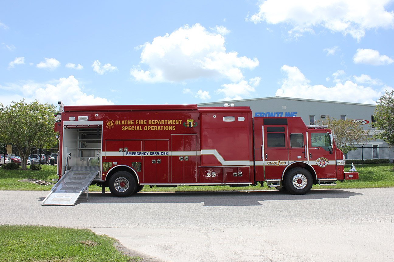 EOD Bomb unit for Olathe Fire Department Special Operations parked outside near the Frontline Communications building on a sunny day.