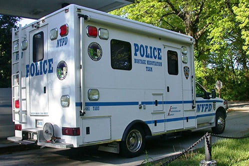 Frontline Communications Hostage Negotiation vehicle for New York Police Department parked outside near trees.
