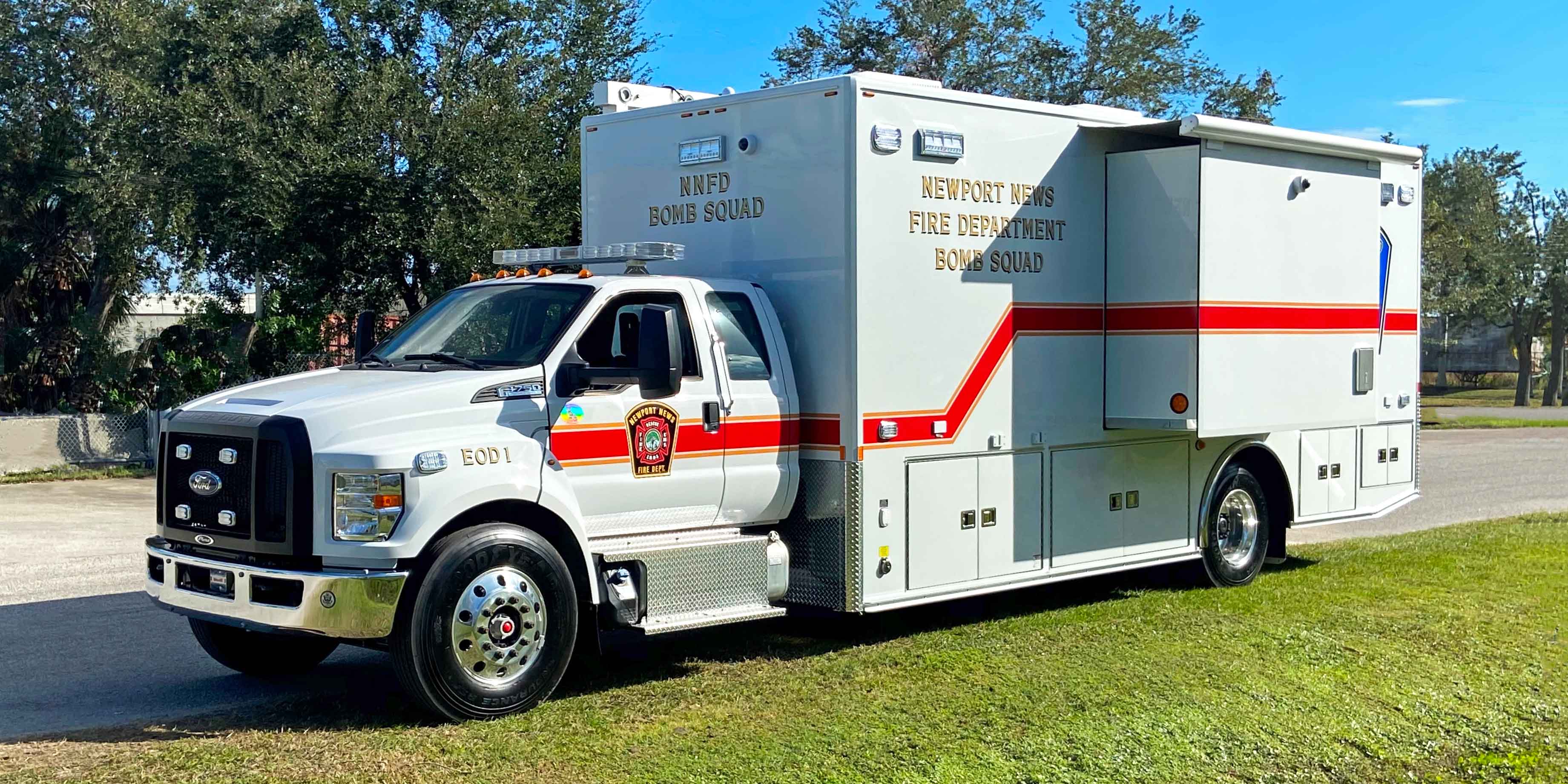 Frontline Communications EOD vehicle parked outside on a sunny day.