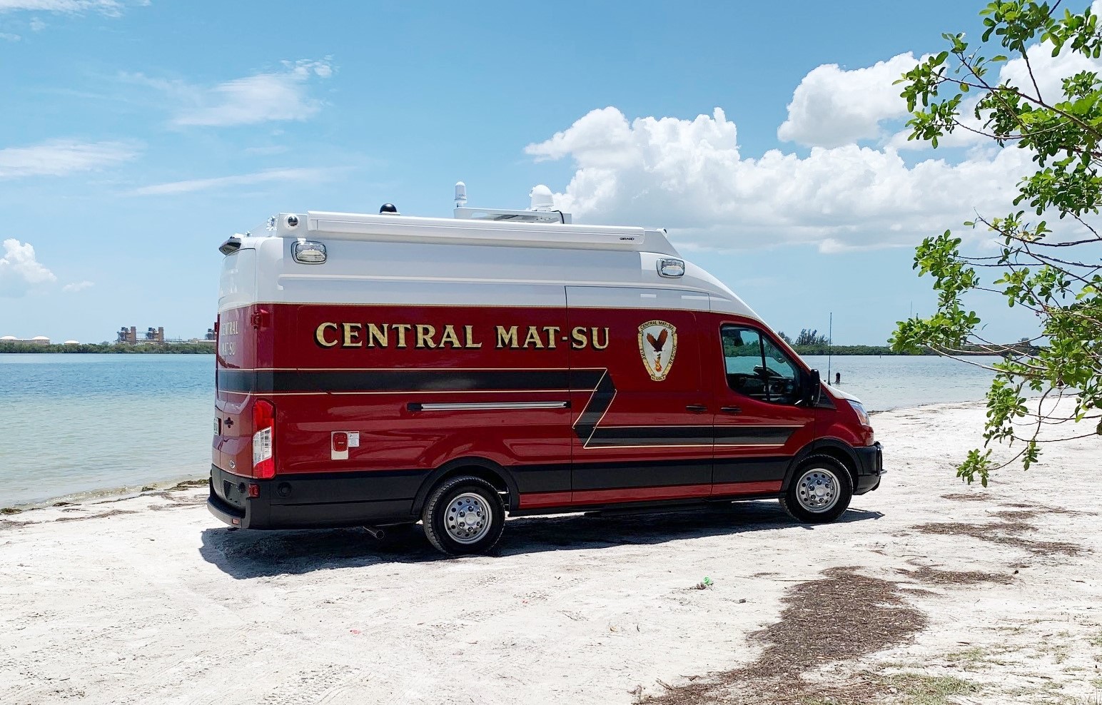 Frontline Communications CRU-22 Mobile Command vehicle parked outside on a beach on a sunny day. 