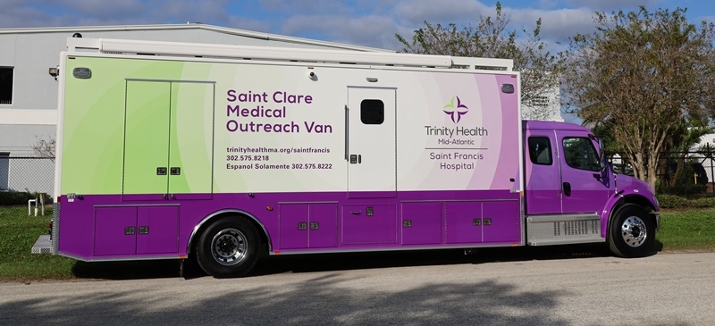 Saint Clare Medical Outreach Specialty Vehicle Van parked outside of the Frontline Communications building on a cloudy day. 