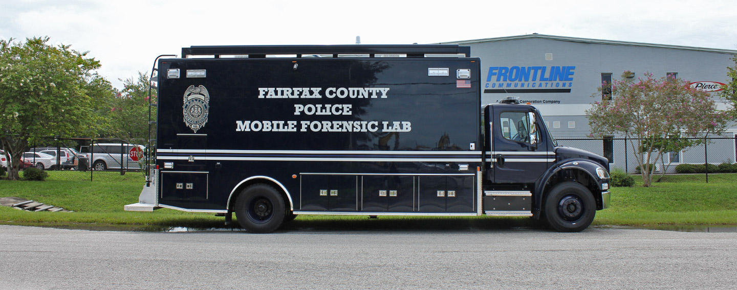 Mobile Crime Lab for Fairfax County Police Department parked outside near the Frontline Communications building on a cloudy day.
