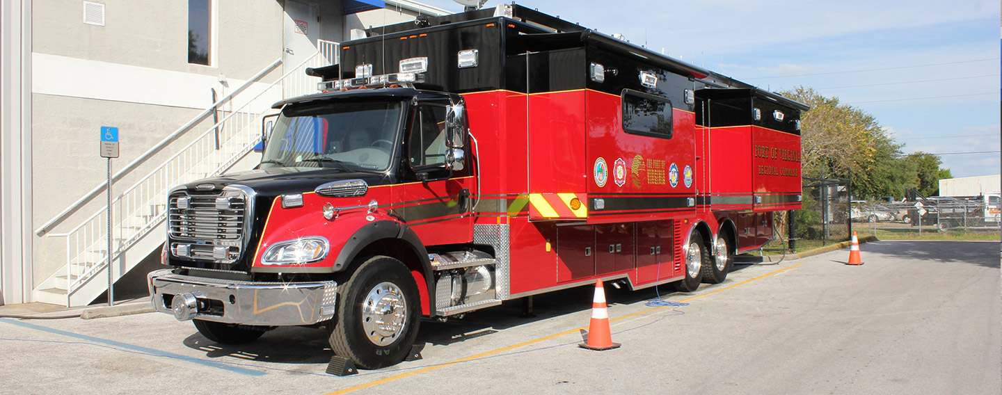 Red Mobile Command vehicle parked outside of the Frontline Communications building.