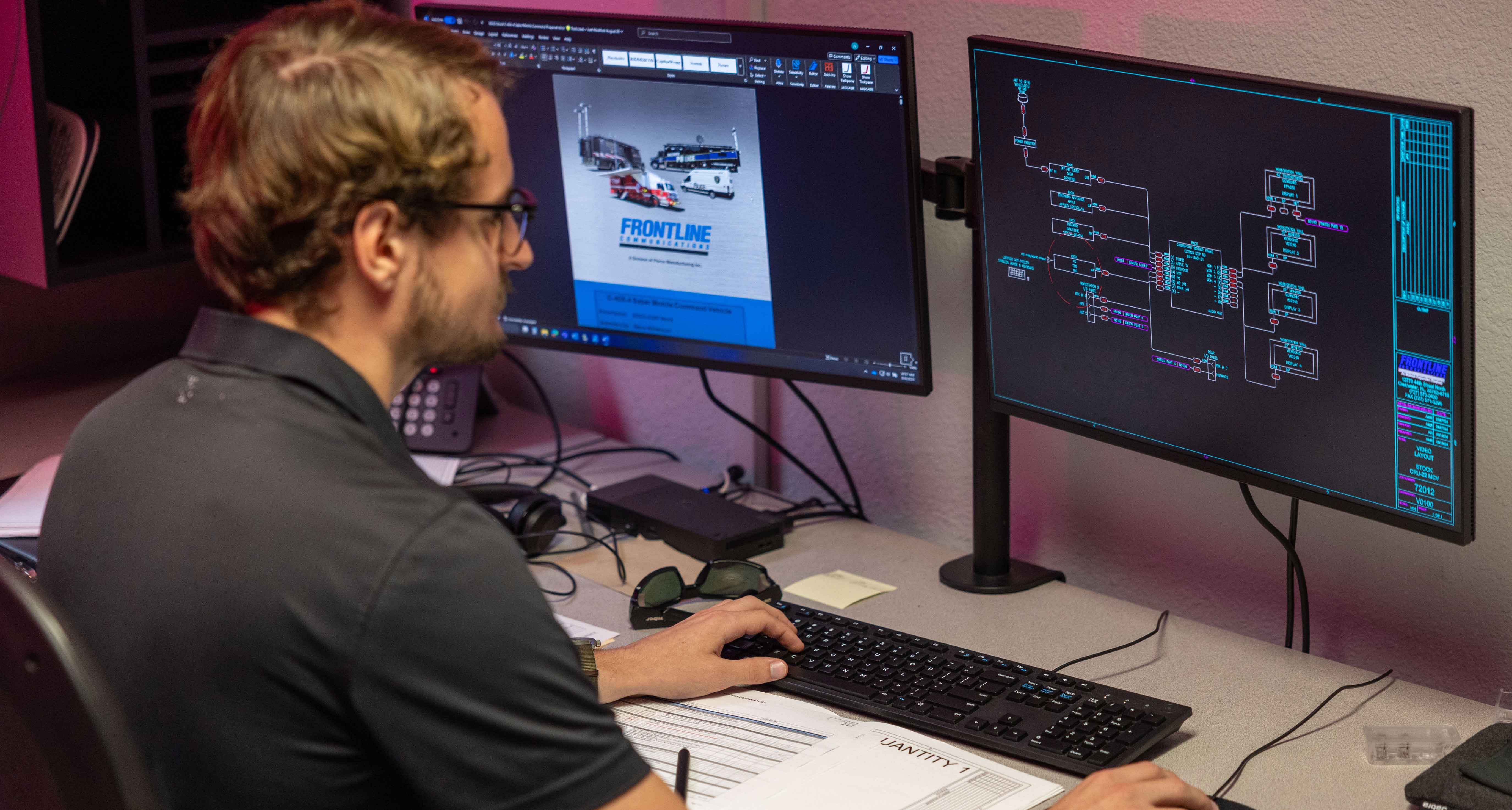 A Frontline Communications team member working at his desk.