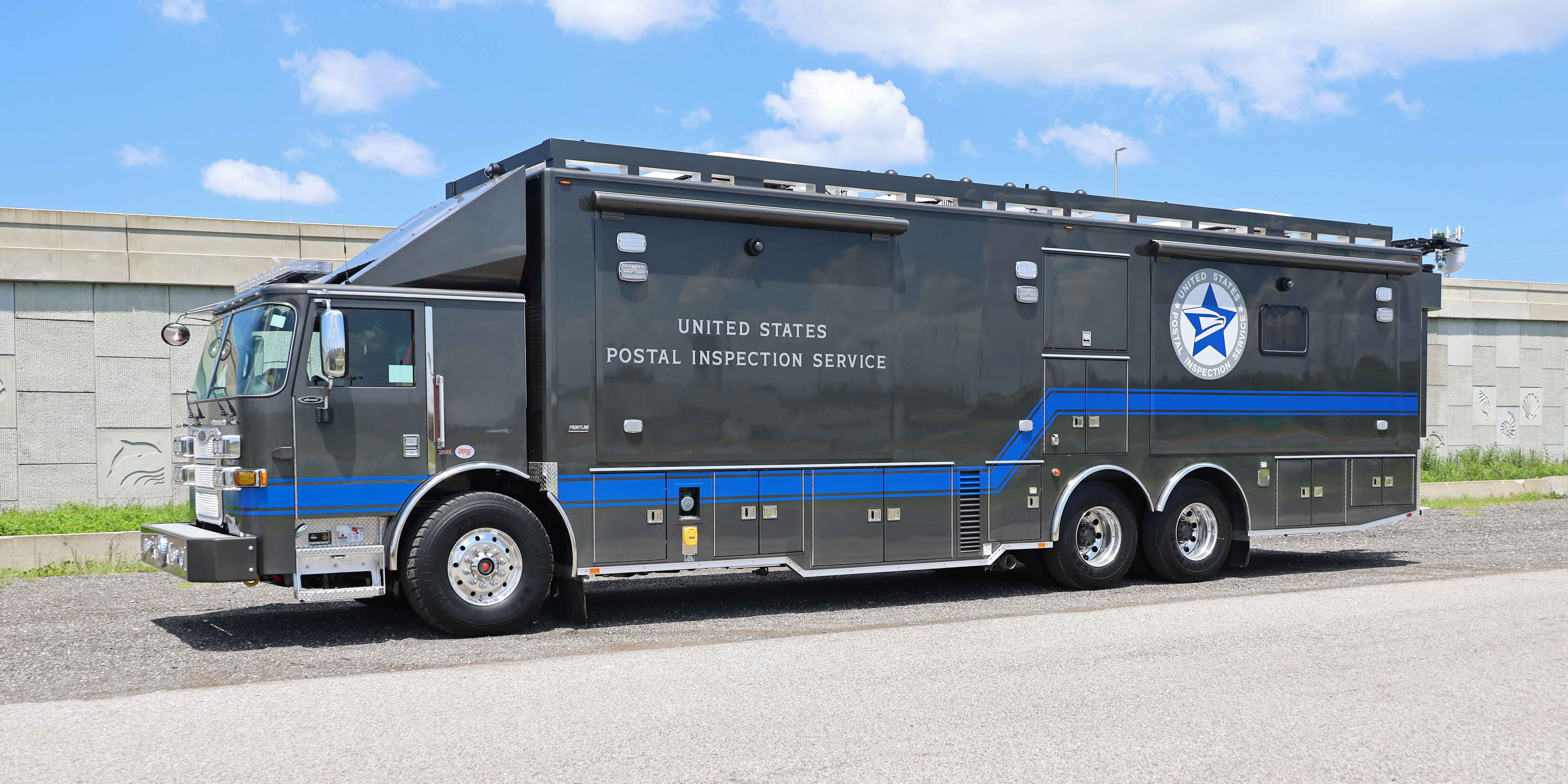 Frontline Communications C-40X-4 Mobile Command Vehicle for the United States Postal Inspection Service parked outside on a sunny day.