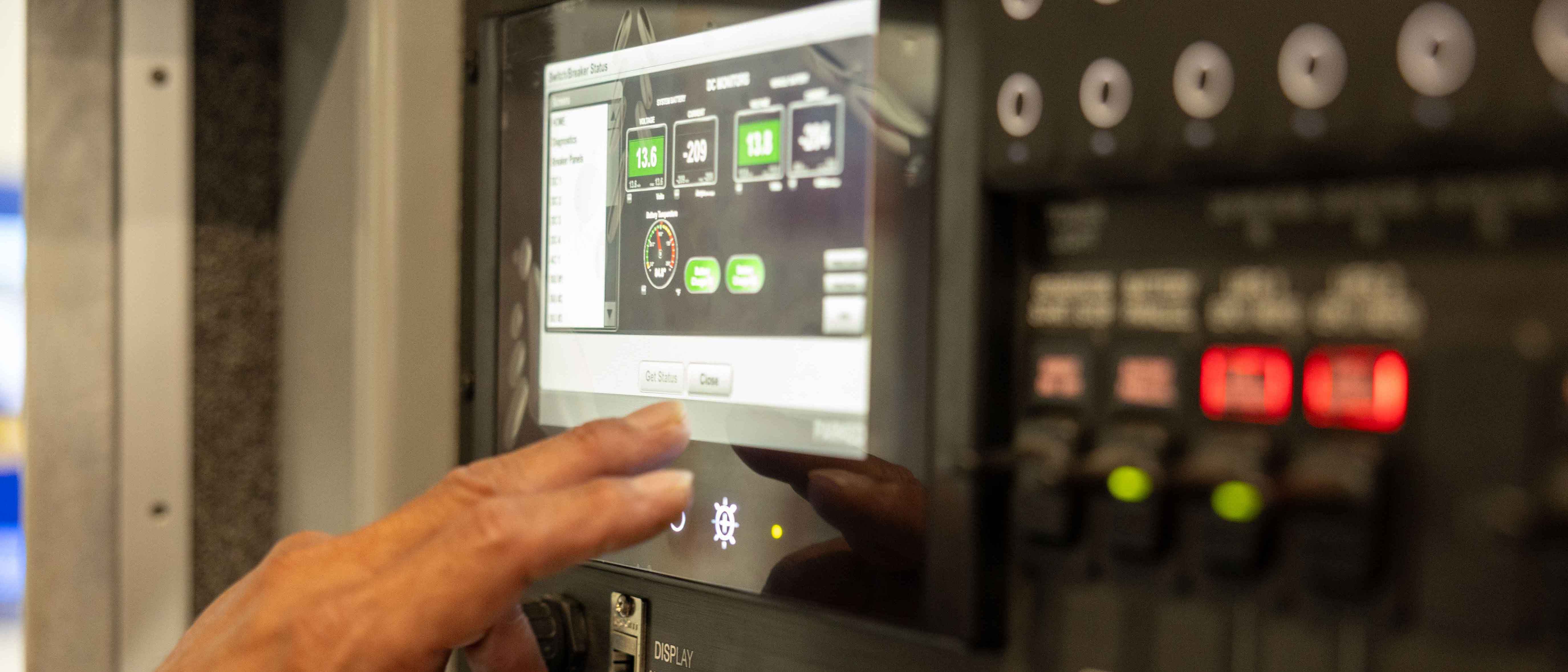 A man utilizing the Frontline Communications Command Zone™ Electrical Systems Screen.