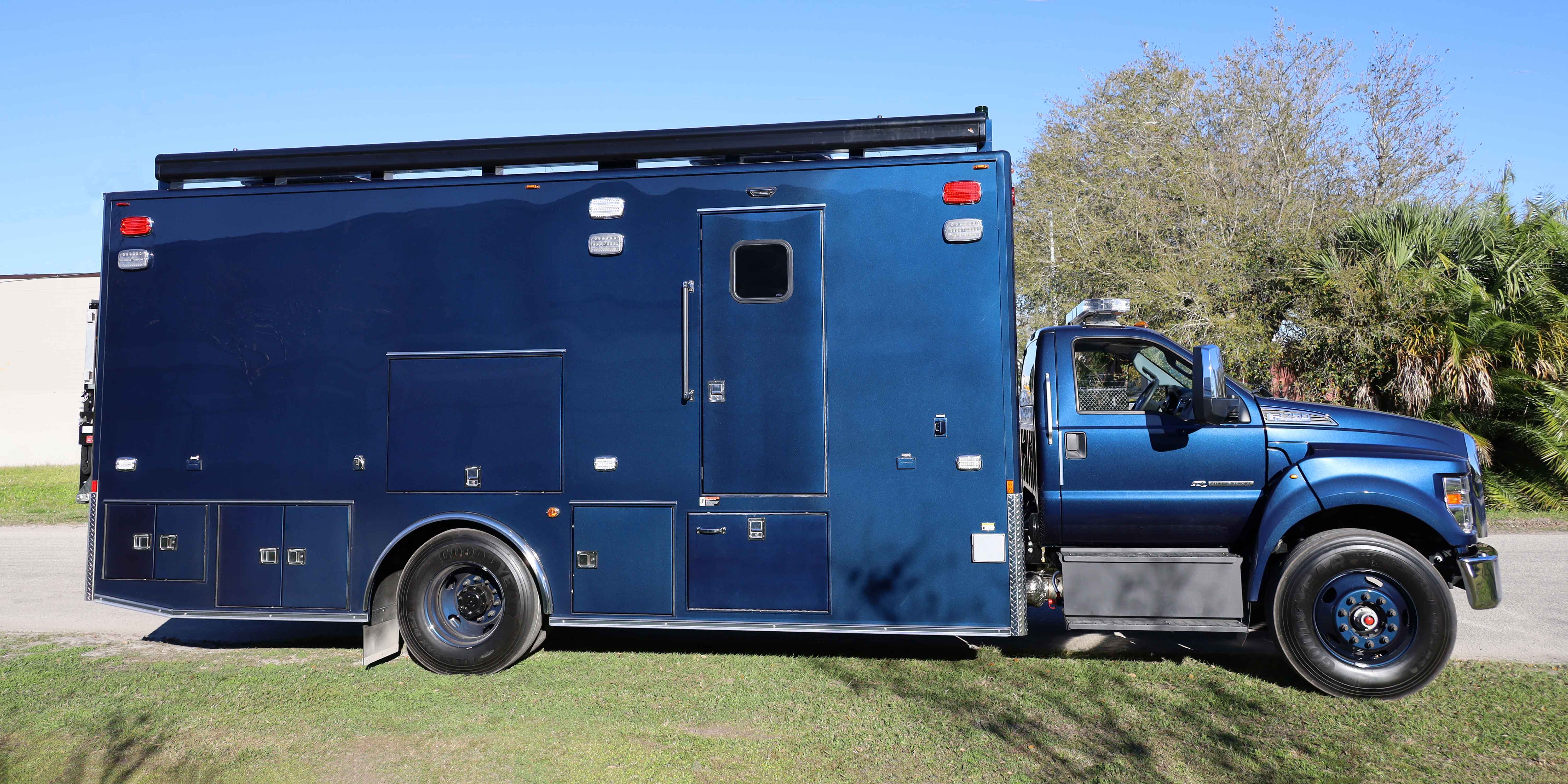 Frontline Communications Specialty Vehicle parked outside on a sunny day.